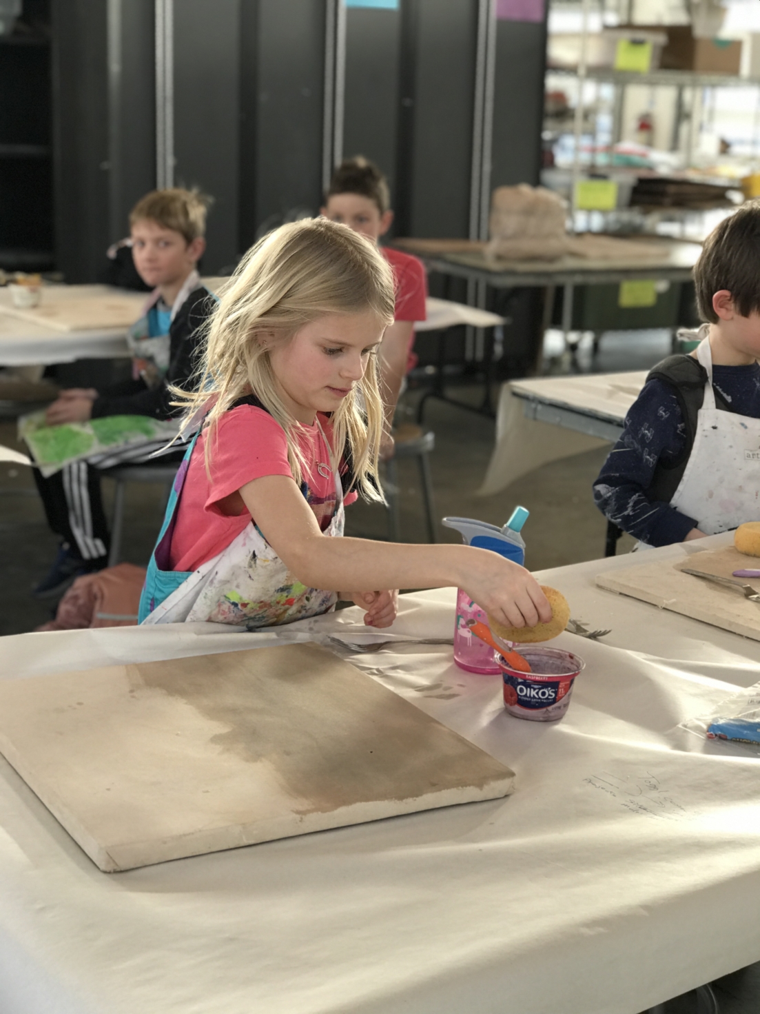 girl making art in child's art class