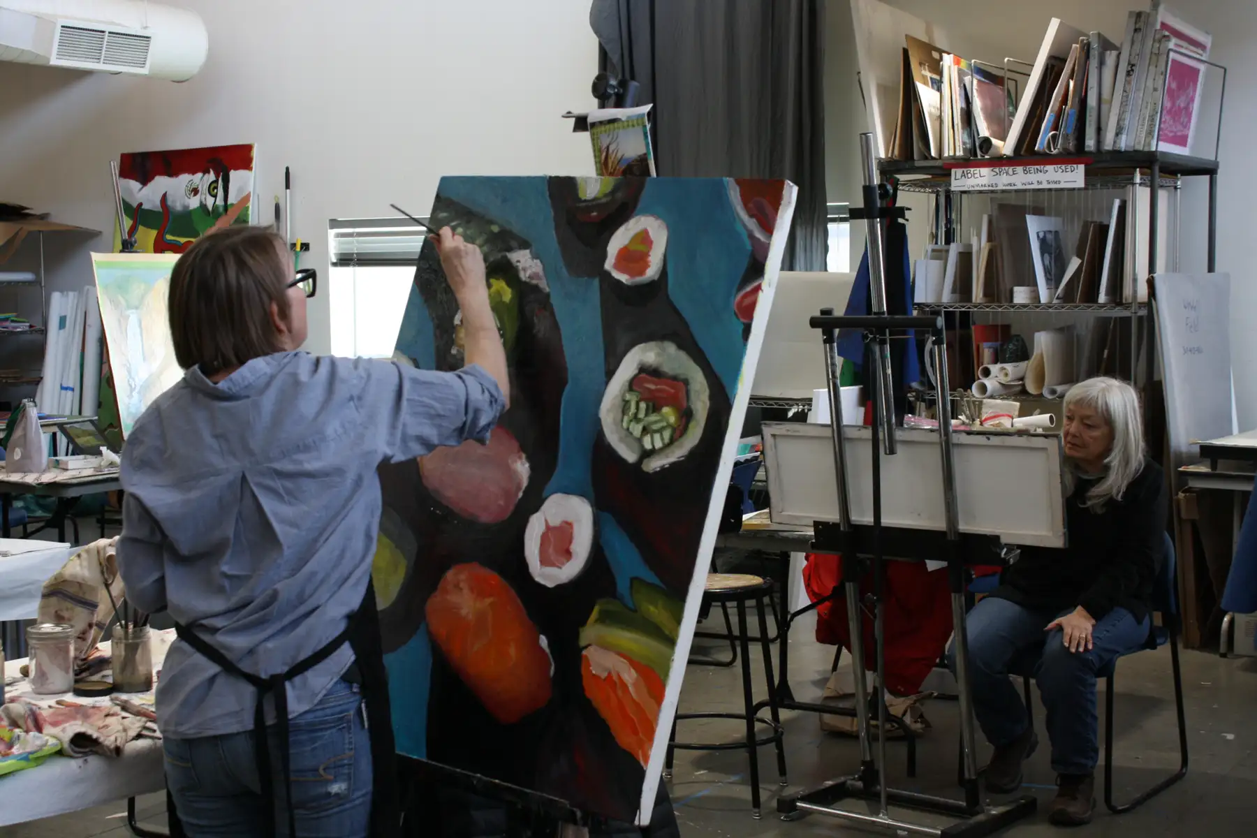 woman painting in art class