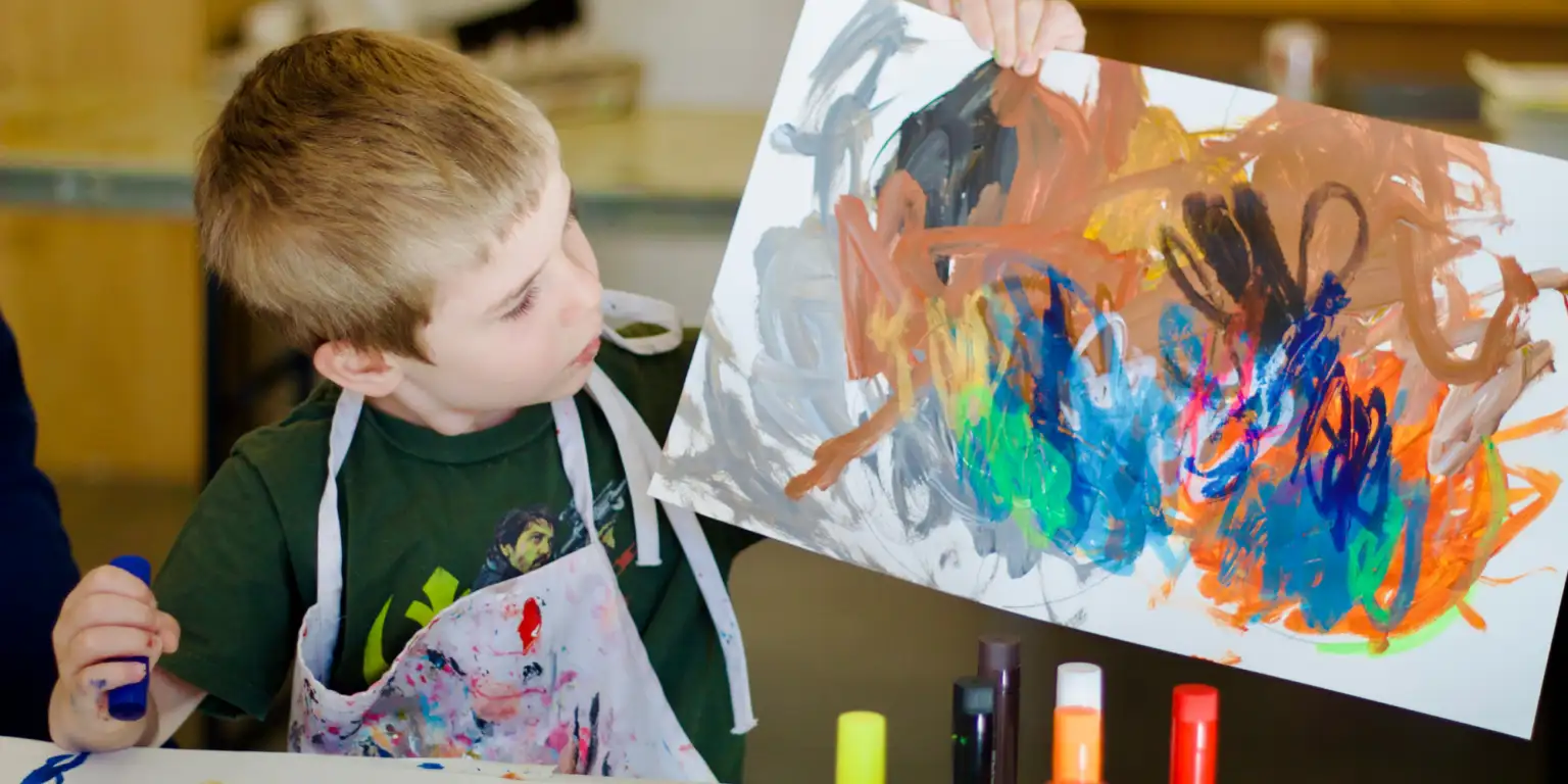 boy showing his artwork