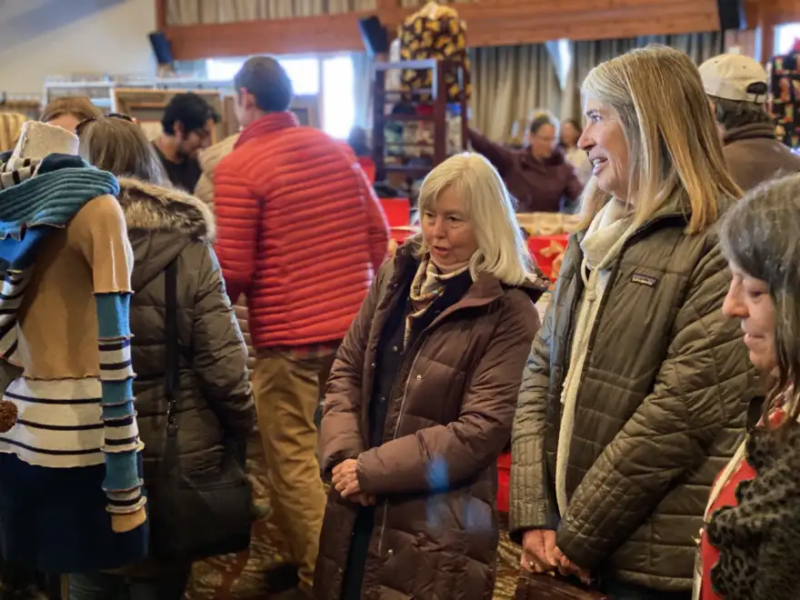 women looking at holiday bazaar items